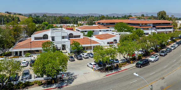 A street view of a town with a church in the center.