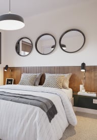 a bedroom with a bed and a chair in a room