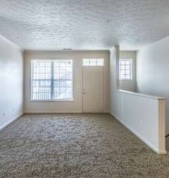 a bedroom with white walls and shelves and a closet