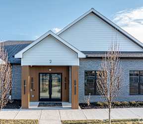 a rendering of a house with a driveway and parking spaces at The Franklin Marlboro, Marlboro