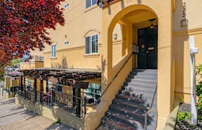 A building with a balcony and stairs.