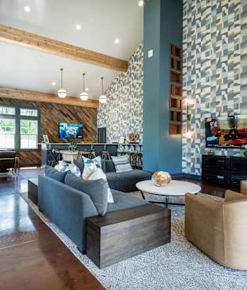 A modern living room with a pool table and a television.