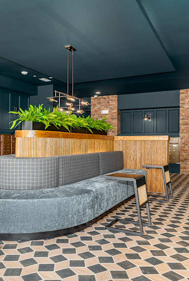 a lobby with couches and chairs and a reception desk