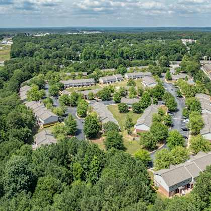 an aerial view of a neighborhood with houses and trees  at Greens at Stonecreek, Georgia