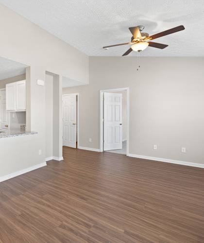 A kitchen with a refrigerator, microwave, and oven.