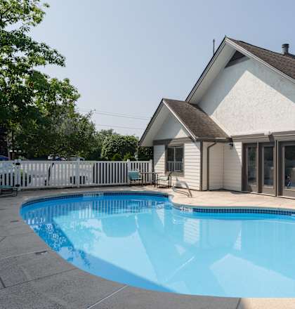 a swimming pool in front of a house