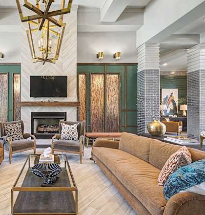 A living room with a fireplace and a large couch.