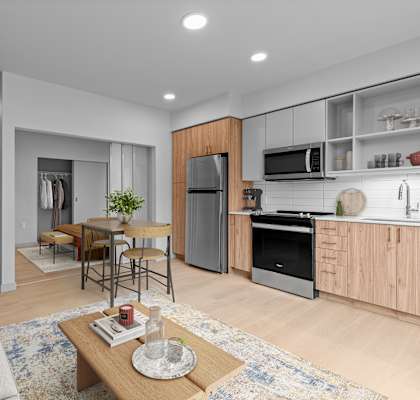 A modern kitchen with wooden cabinets and stainless steel appliances.
