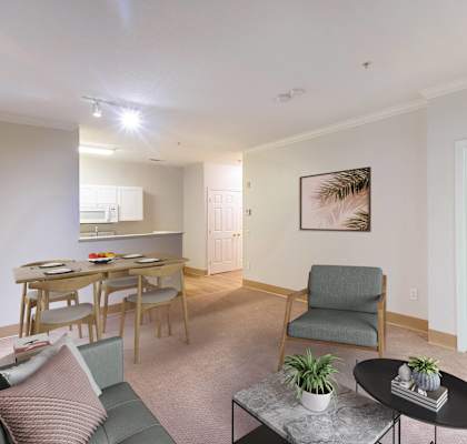 a living room with a couch and a chair and a dining table at Woodlands at Abington Station, Abington