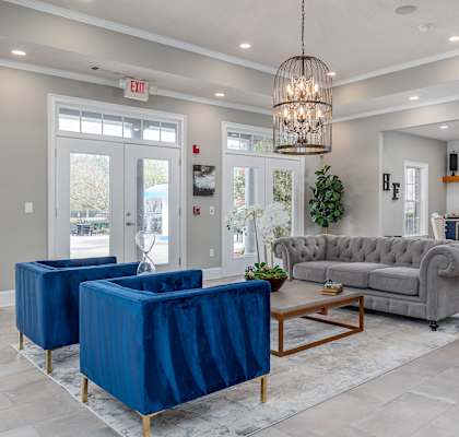 A living room with a grey sofa, a blue chair and a wooden coffee table.