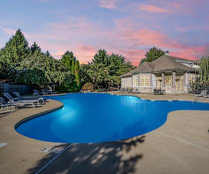 A large swimming pool with a gazebo in the background.