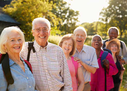 a group of people standing in a line and smiling