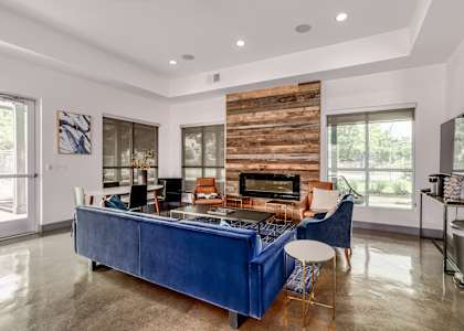 a living room with a blue couch and a fireplace