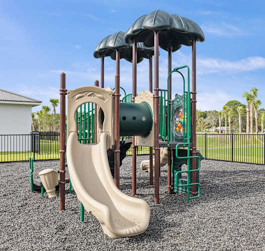 a playground with a slide and climbing equipment in a park