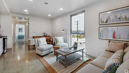 A modern living room with a large window and a view of the outdoors.