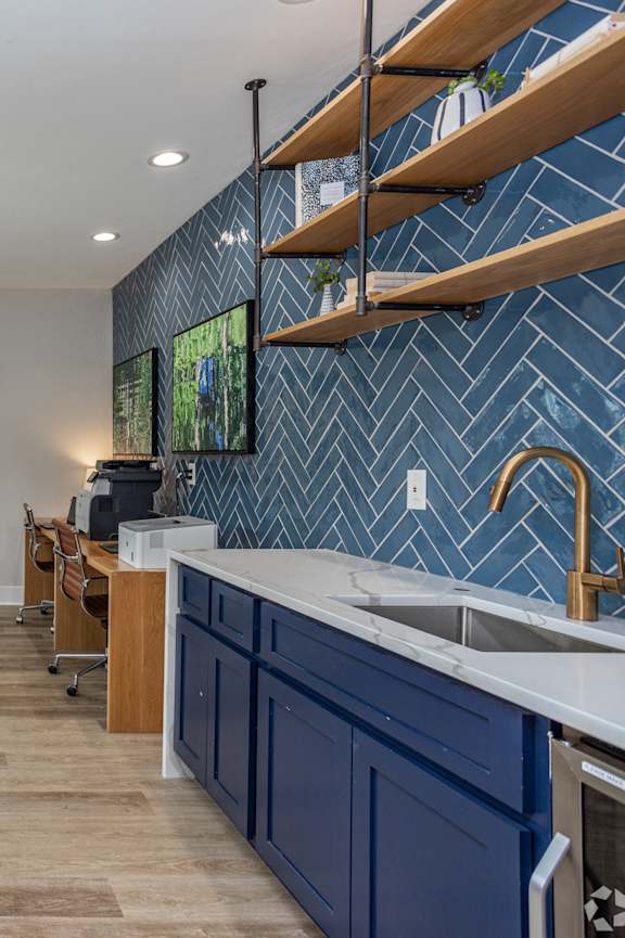 A kitchen with a stainless steel sink and a white counter at Waterleaf at Neely Ferry Apartments, Simpsonville, SC 29680