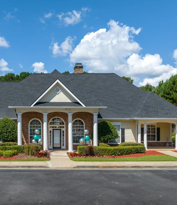 A house with a grey roof and a white front porch at Alexander Ridge Apartments in Canton, GA
