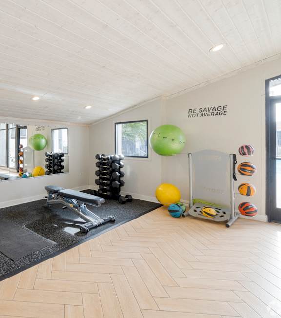 A spacious room with a variety of exercise equipment.