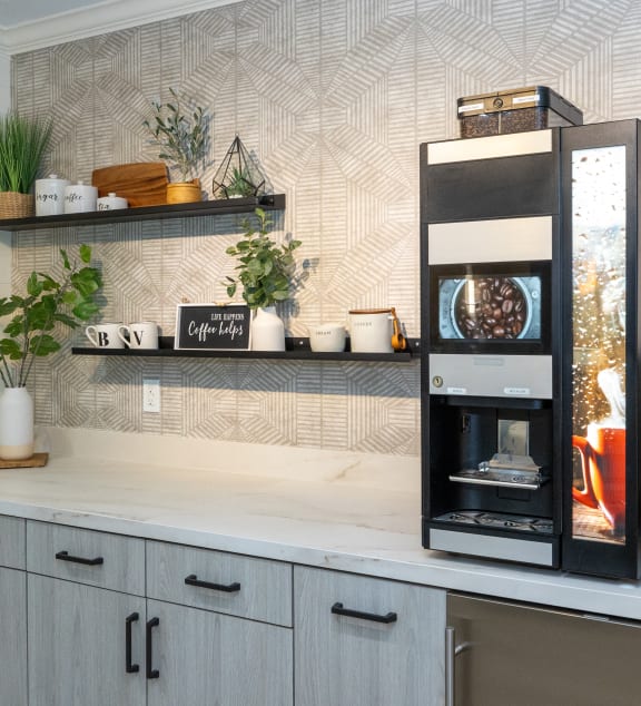 a kitchen with an espresso machine and a coffee maker on a counter