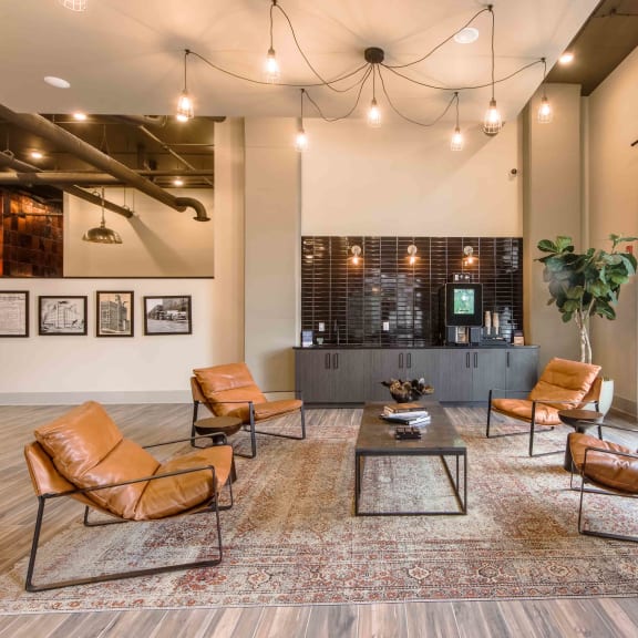 a lobby with leather chairs and a coffee table