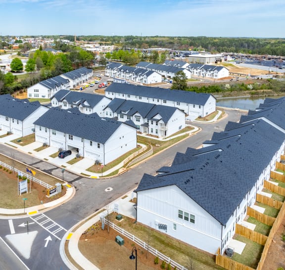 an aerial view of a group of houses in a parking lot