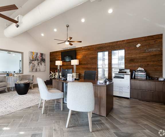 A modern home office with a white chair and a wooden desk.