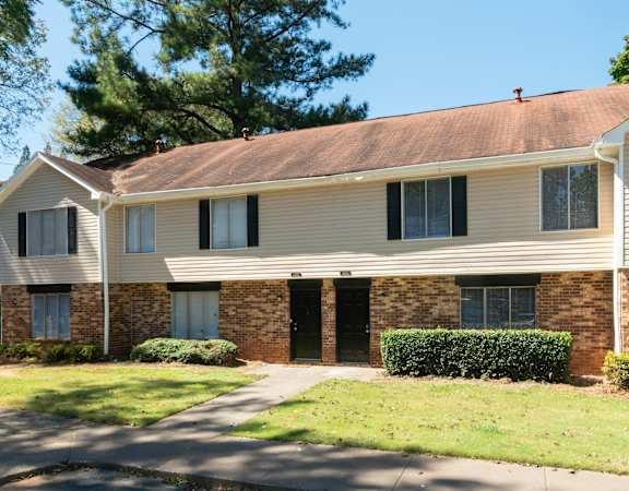 a white house with a sidewalk in front of it at Hidden Woods, Decatur, 30035