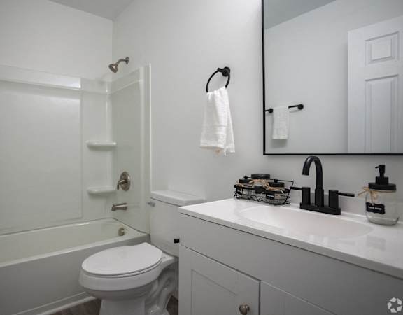 a bathroom with a sink toilet and a bath tub