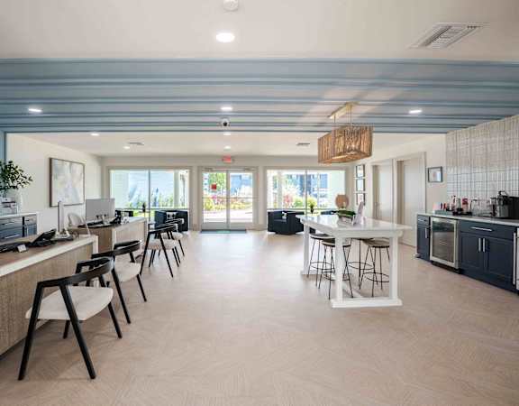 a dining room with tables and chairs and a bar