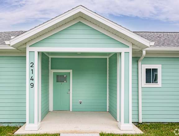 the front of a blue house with a front porch