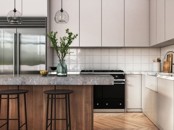 a kitchen with white cabinets and a marble counter top