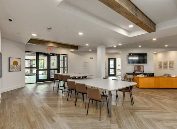 A conference room with a long table and chairs.