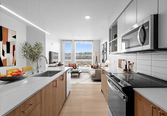 A modern kitchen with a view of the city.
