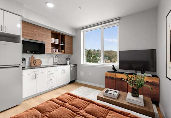 A modern kitchen with white cabinets and a wooden countertop.