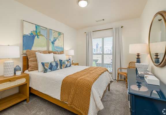 a bedroom with a bed and a dresser and a window