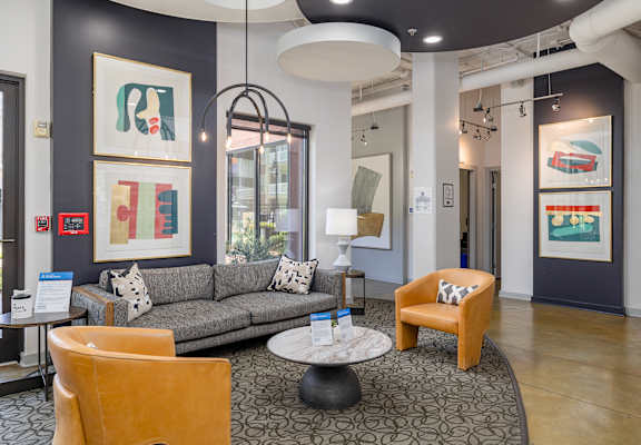 a living room with a couch and chairs and a table