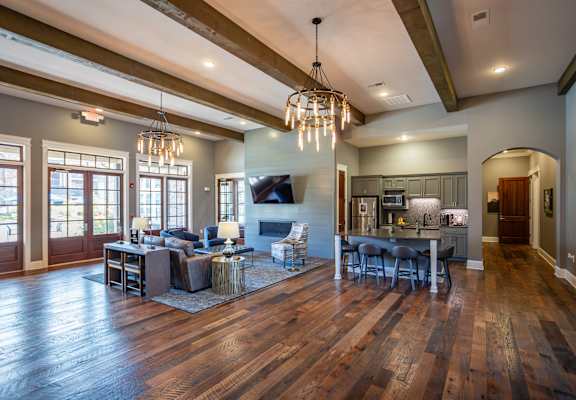 the living room and dining room of a house with wood floors