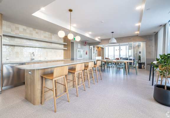 A modern kitchen with a long island and bar stools.