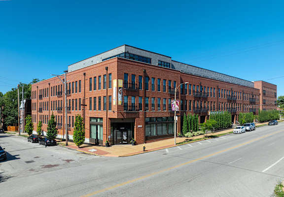 A large red brick building with a black awning on the front. at 1400 Russell Apartments, Saint Louis, MO, 63104