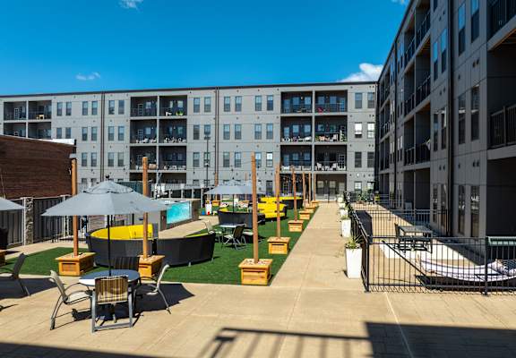 A sunny day at the outdoor seating area of a modern apartment complex. at 1400 Russell Apartments, Saint Louis, MO, 63104