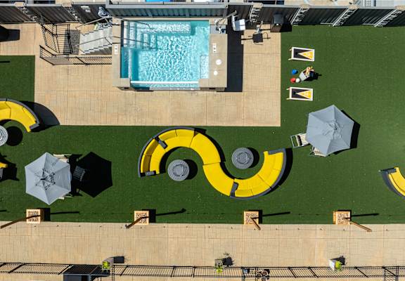 A pool with a yellow and black design on the grass. at 1400 Russell Apartments, Saint Louis, MO, 63104