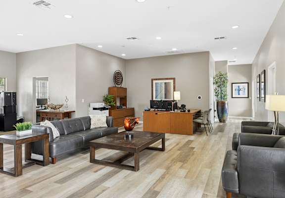 A living room with a grey couch and a wooden coffee table.