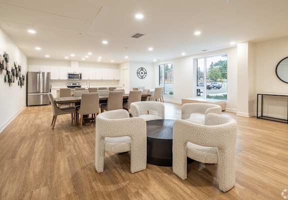 a dining room with a table and chairs and a kitchen