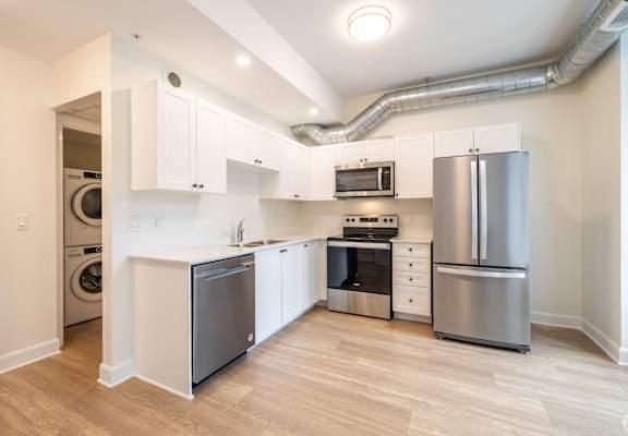 a kitchen with stainless steel appliances and white cabinets