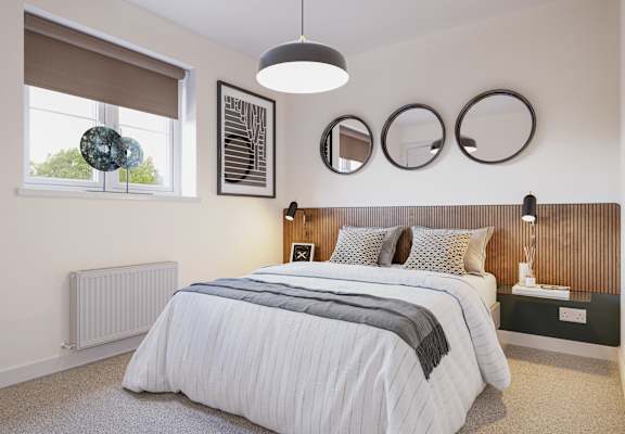 a bedroom with a bed and two mirrors on the wall