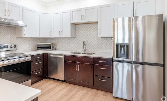 A modern kitchen with a stainless steel refrigerator.
