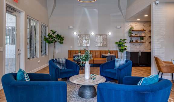 A living room with blue chairs and a white ceiling.