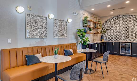 A modern dining area with a round table and chairs.