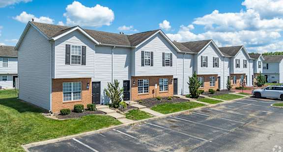 A row of townhouses with a car parked in front.