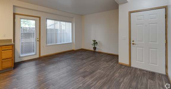 A room with a wooden floor and white walls.
